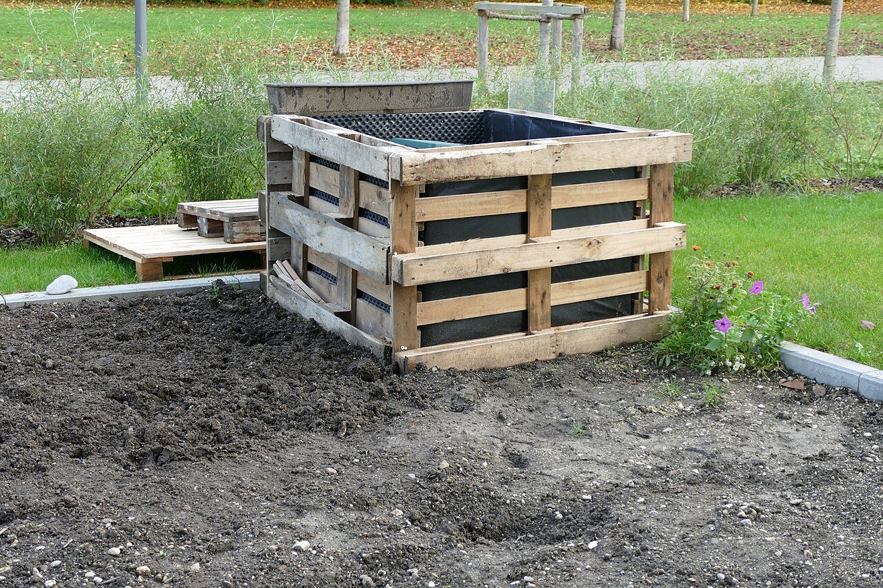 Prepared raised flower bed built from reused wooden pallets before planting